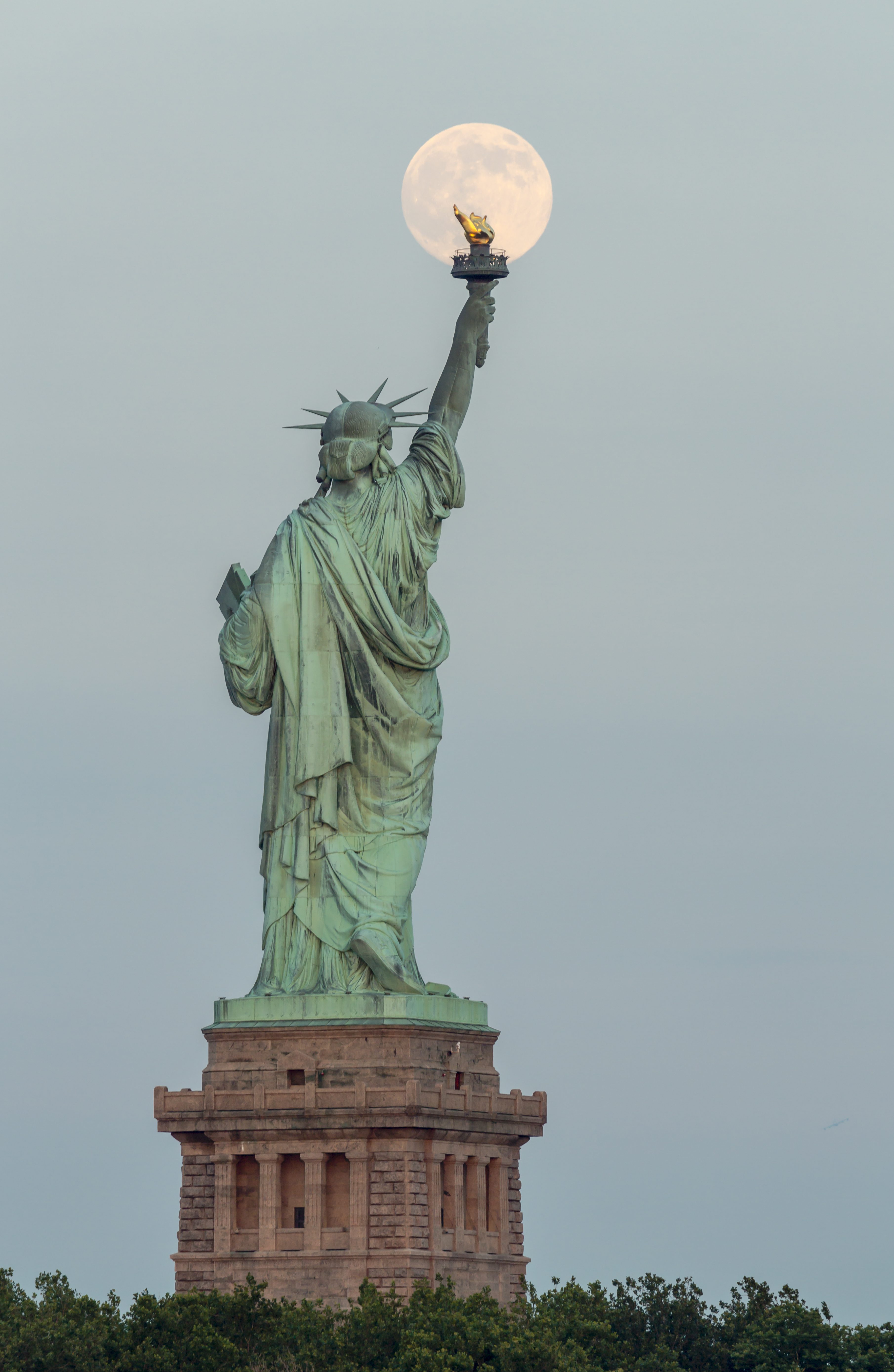 Super Moon Rises Over The Statue Of Liberty